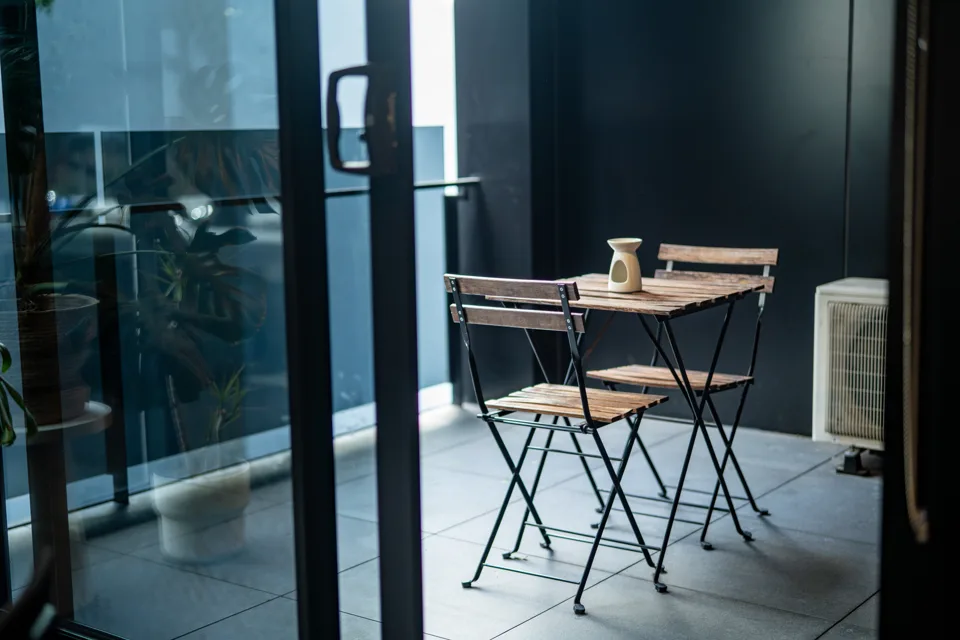 Balcony with a bistro table and two chairs