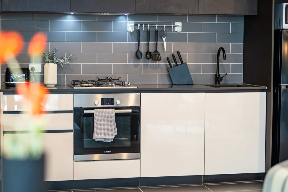Kitchen with oven and tiled splashback